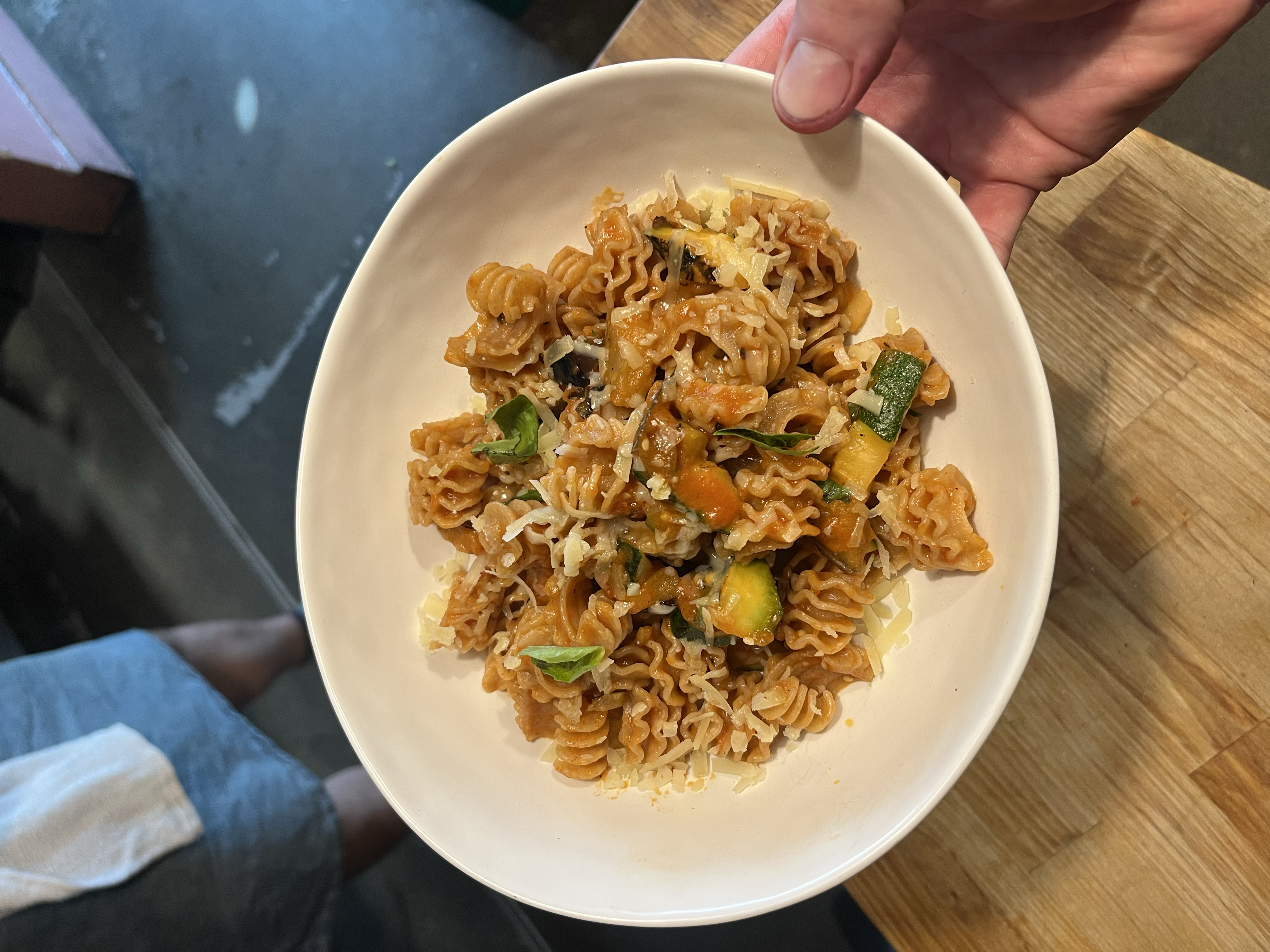Handmade radiatori pasta with vibrant pomodoro sauce, featuring marinated eggplant, fresh zucchini, basil and local Ferndale cheese