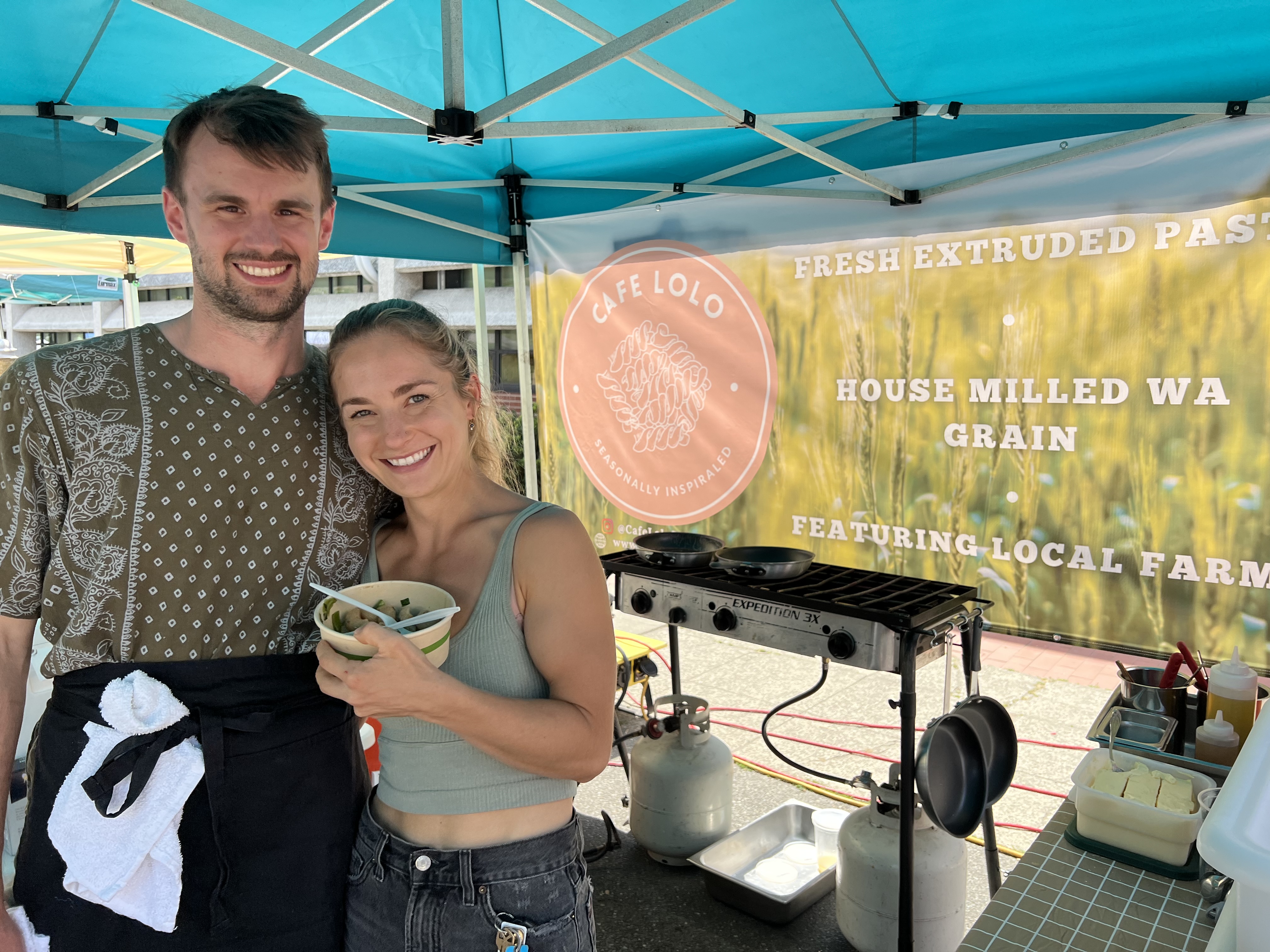 leah and alex at their farmers market stand